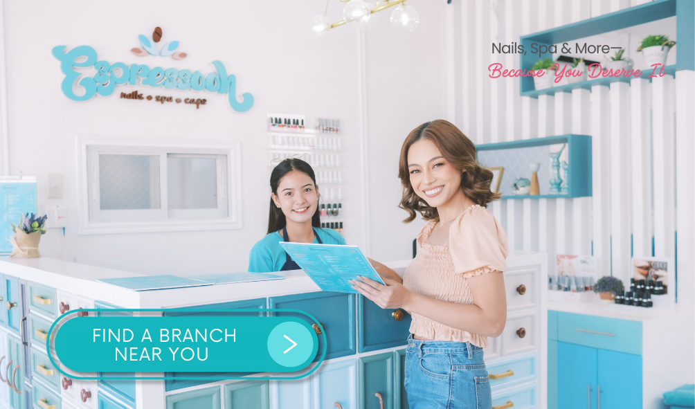 A happy customer reviewing the service menu with an Espressooh Nail Spa receptionist. The beautifully designed spa interior features pastel blue and white decor. The text reads 'Nails, Spa & More—Because You Deserve It,' with a 'FIND A BRANCH NEAR YOU' button